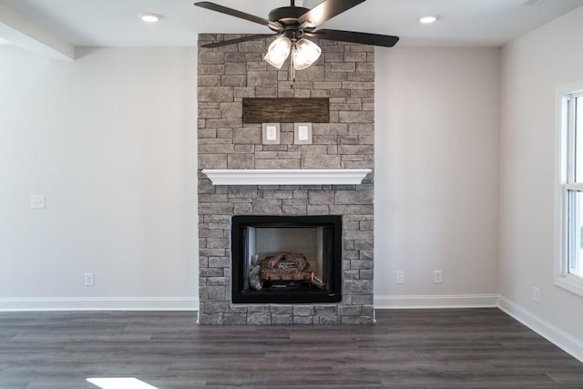 unfurnished living room with dark hardwood / wood-style flooring, a fireplace, and ceiling fan