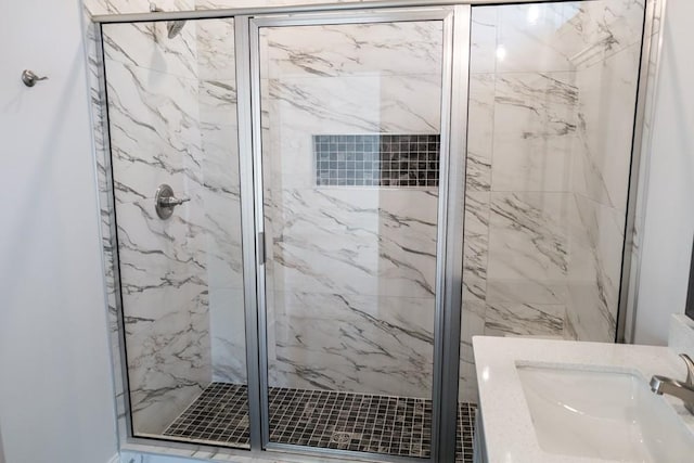 bathroom with vanity and a shower with shower door