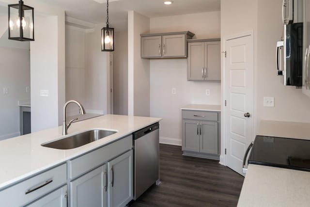 kitchen with pendant lighting, sink, gray cabinetry, and appliances with stainless steel finishes