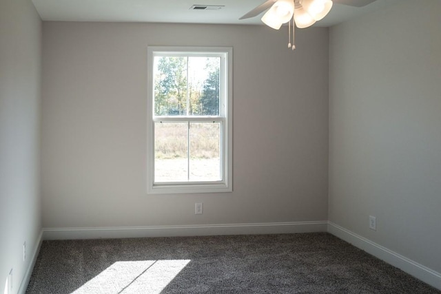 carpeted empty room featuring a healthy amount of sunlight and ceiling fan