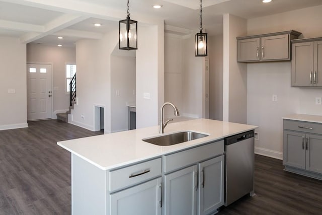 kitchen featuring pendant lighting, sink, a kitchen island with sink, dark hardwood / wood-style floors, and stainless steel dishwasher