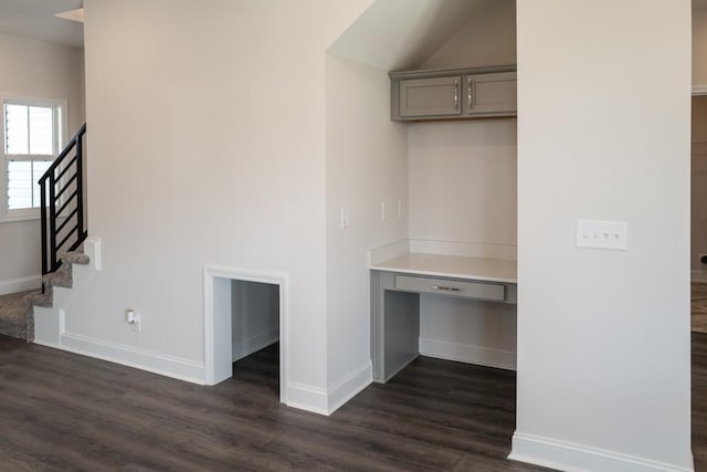 interior space featuring built in desk and dark hardwood / wood-style floors