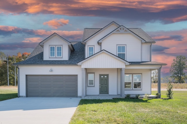 view of front of home with a yard, a garage, and a porch