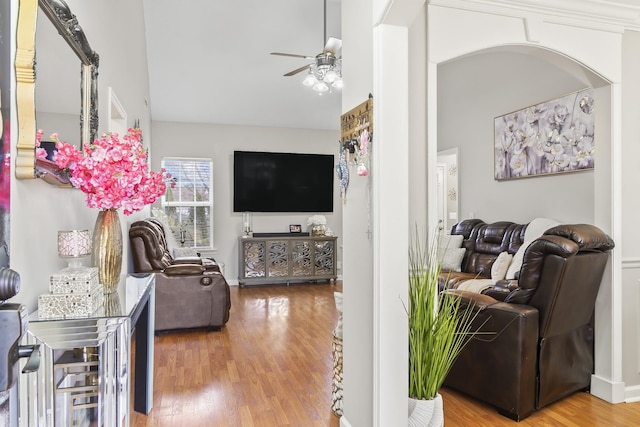 living room with lofted ceiling, wood-type flooring, and ceiling fan