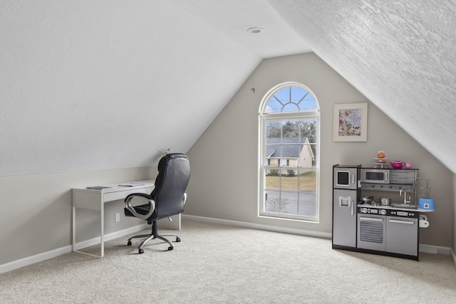 carpeted office space with lofted ceiling and a textured ceiling