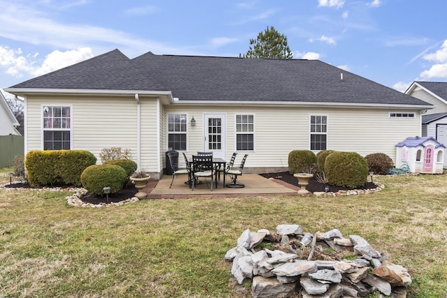 rear view of property featuring a yard and a patio