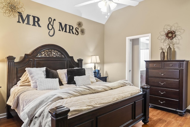 bedroom featuring vaulted ceiling, ceiling fan, and light wood-type flooring