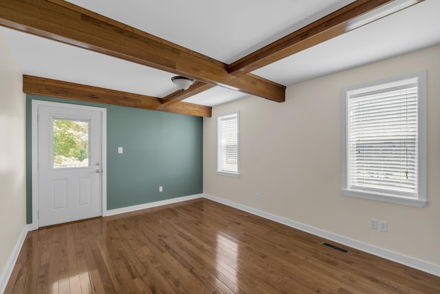 interior space featuring wood-type flooring, beamed ceiling, and plenty of natural light