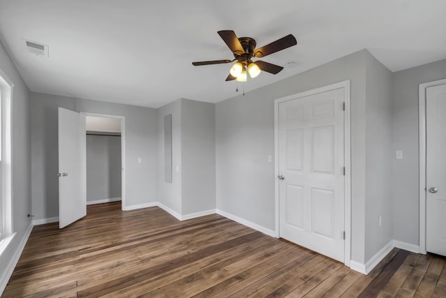 unfurnished bedroom featuring dark wood-type flooring and ceiling fan