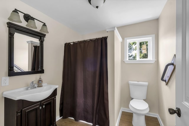 bathroom with vanity, toilet, and hardwood / wood-style floors