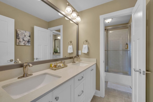 bathroom with enclosed tub / shower combo, tile patterned floors, and vanity