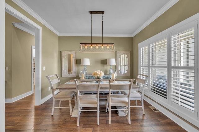 dining area featuring crown molding and dark hardwood / wood-style flooring