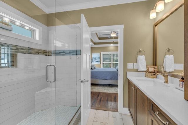 bathroom with vanity, crown molding, a shower with door, and ceiling fan