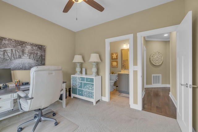 home office featuring light colored carpet and ceiling fan