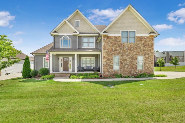 craftsman inspired home featuring a front yard and a porch