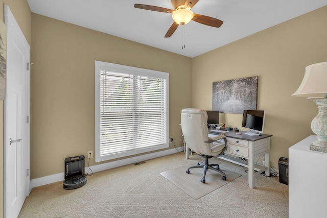 carpeted office space with ceiling fan