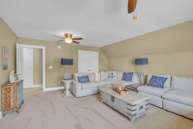 carpeted living room featuring vaulted ceiling and ceiling fan