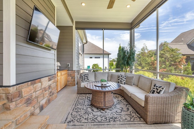 sunroom / solarium featuring ceiling fan