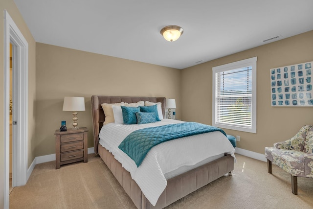 bedroom with light colored carpet