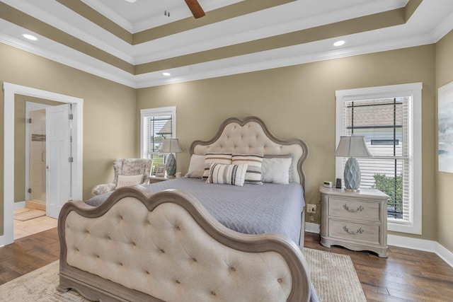 bedroom with crown molding, a raised ceiling, and hardwood / wood-style floors