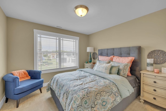 bedroom featuring light colored carpet