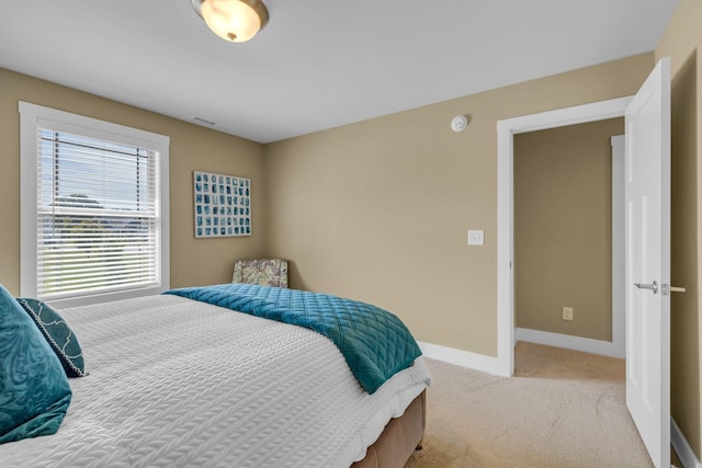 bedroom featuring light carpet