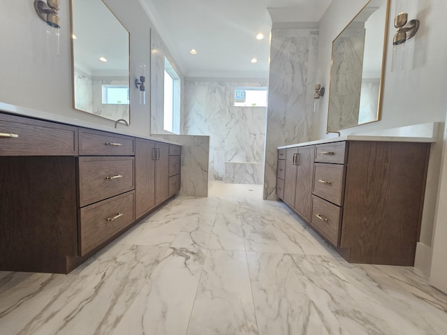 bathroom featuring walk in shower, vanity, and tile walls