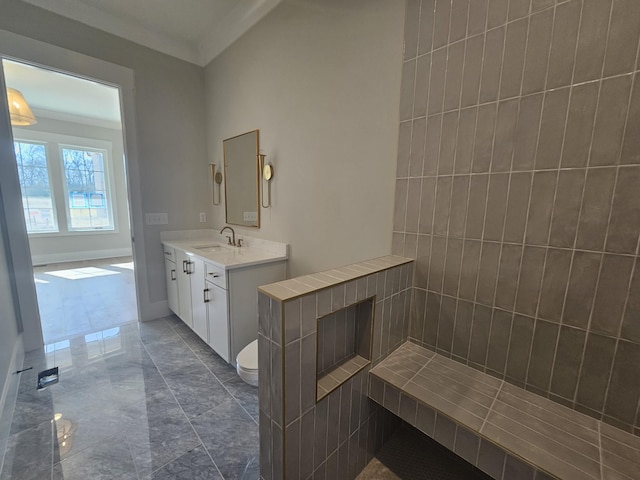 bathroom with crown molding, vanity, and toilet