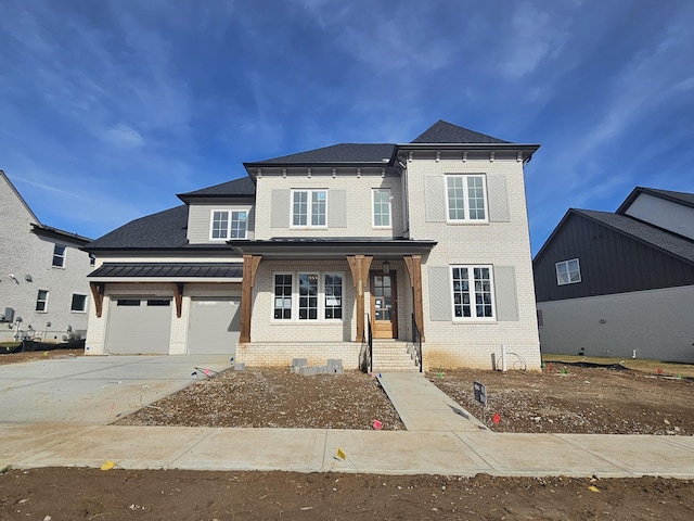 view of front of property with a garage and covered porch