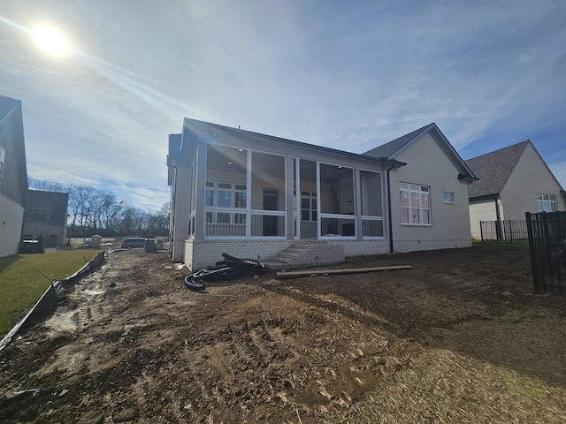 back of property featuring a sunroom