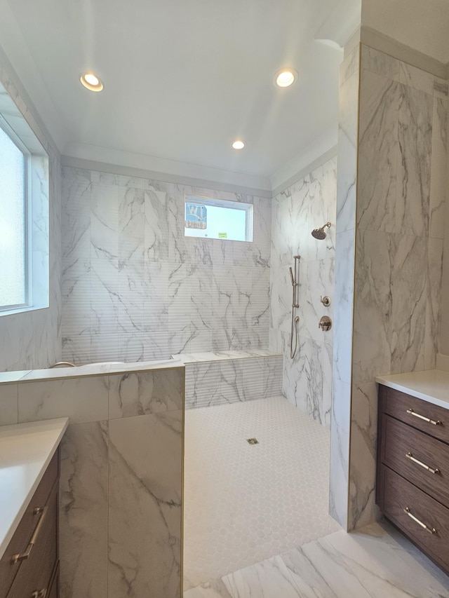 bathroom featuring vanity, tile walls, and a tile shower