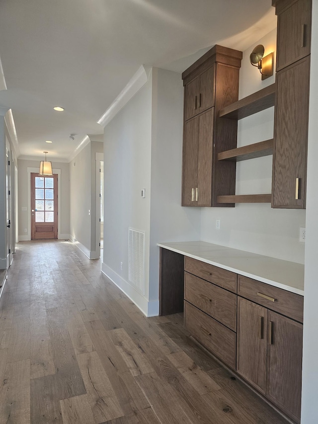 kitchen with pendant lighting and dark hardwood / wood-style flooring