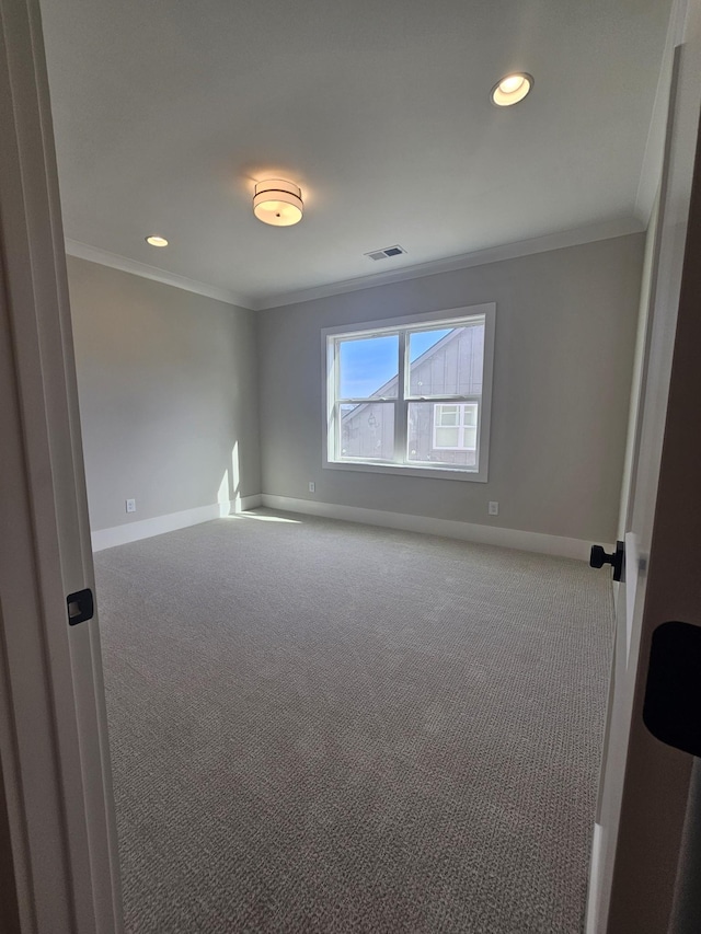 carpeted spare room with ornamental molding