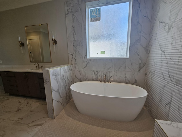 bathroom with vanity and a tub