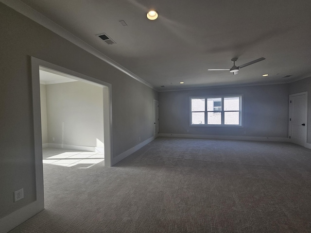 empty room featuring crown molding, ceiling fan, and carpet flooring