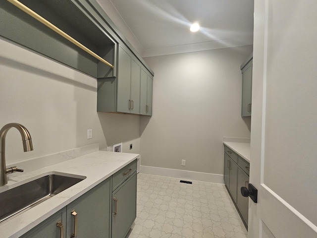 clothes washing area with cabinets, electric dryer hookup, sink, and hookup for a washing machine