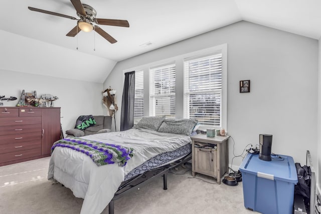 bedroom featuring light carpet, vaulted ceiling, and ceiling fan