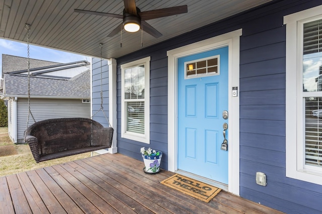 doorway to property featuring covered porch and ceiling fan