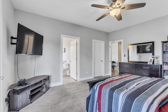 carpeted bedroom featuring ensuite bath and ceiling fan