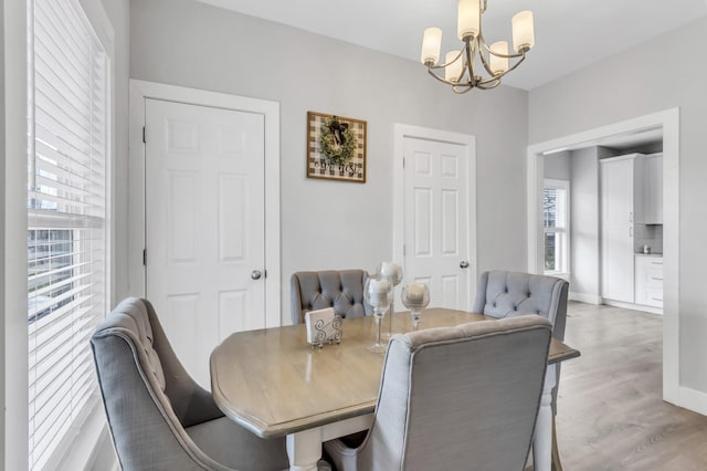 dining room featuring light hardwood / wood-style flooring and a chandelier