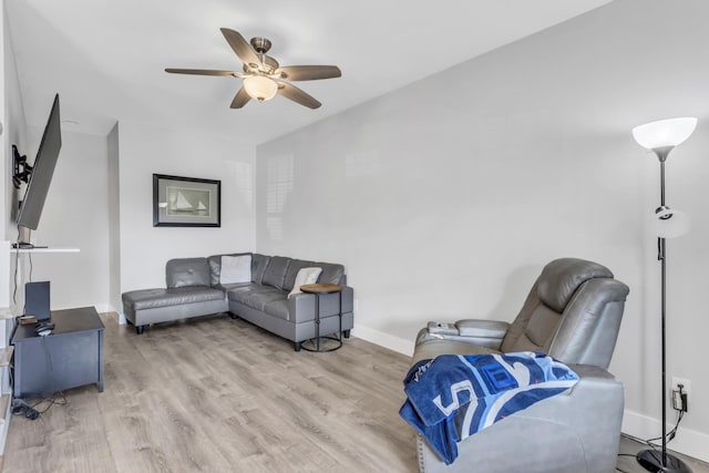 living room featuring ceiling fan and light wood-type flooring