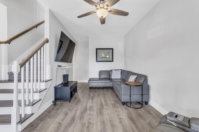 living room featuring ceiling fan and light wood-type flooring