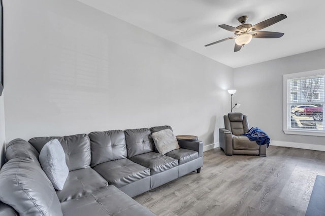 living room with ceiling fan and light wood-type flooring