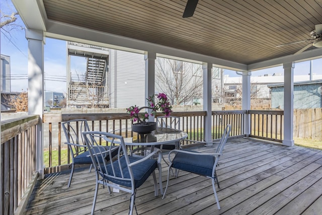 wooden deck featuring ceiling fan