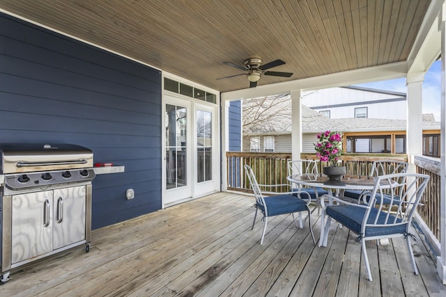 wooden deck with ceiling fan and a grill