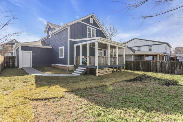 rear view of property featuring a lawn