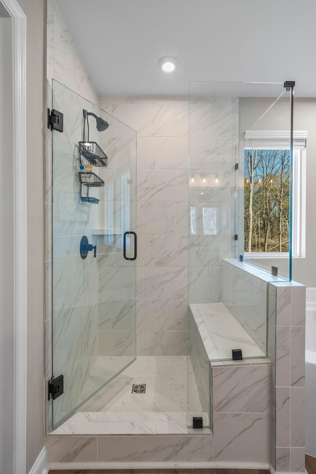 bathroom featuring a shower with shower door