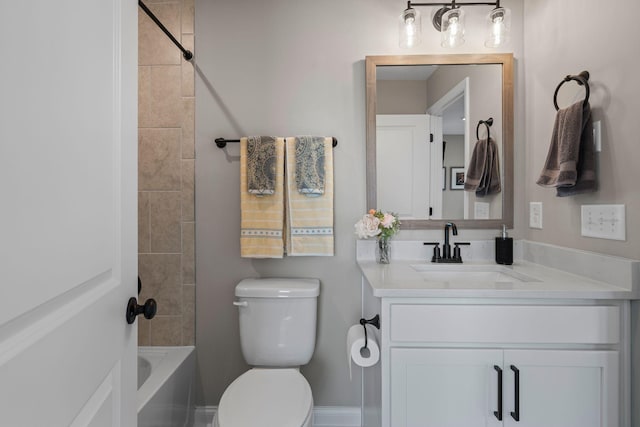 full bathroom featuring vanity, tiled shower / bath combo, and toilet