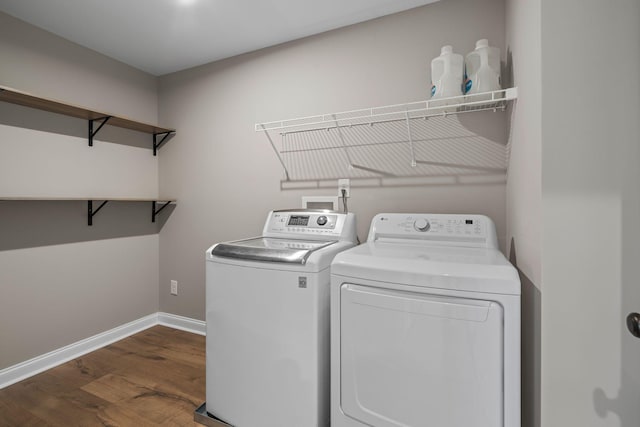 laundry room with dark wood-type flooring and independent washer and dryer