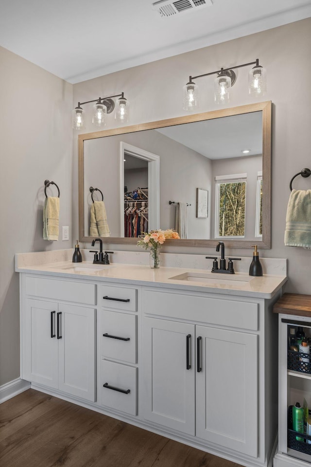 bathroom with vanity and wood-type flooring